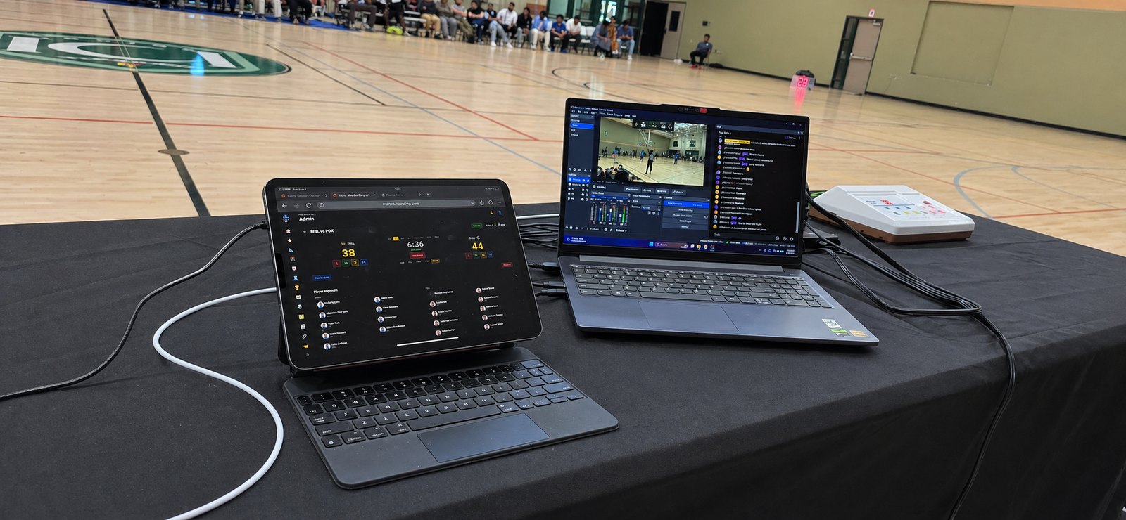 ScoreLM courtside broadcast setup — tablet running the scorebug control next to the production laptop